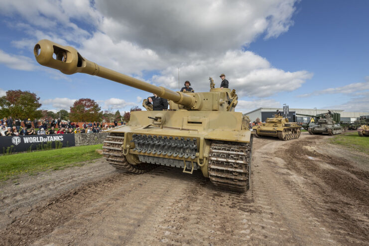 Tiger 131 and other tanks driving around a dirt track