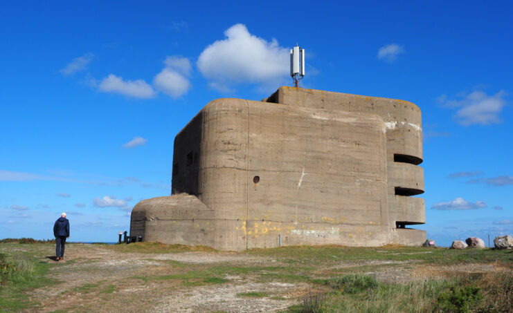 Man standing outside the Odeon, an MP3 concrete tower