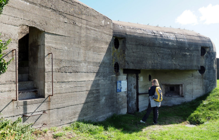 Woman standing outside a World War II structure