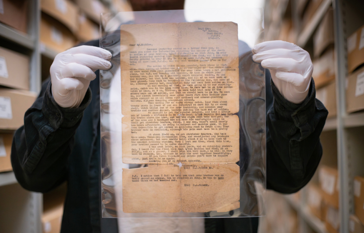 Man holding up the letter written by Lt. D.A. Palmer