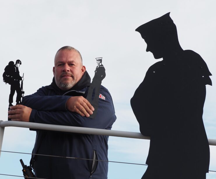 Dan Barton standing next to one of his figures