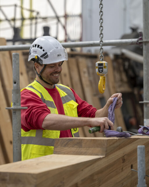 Shipwright working on large timbers