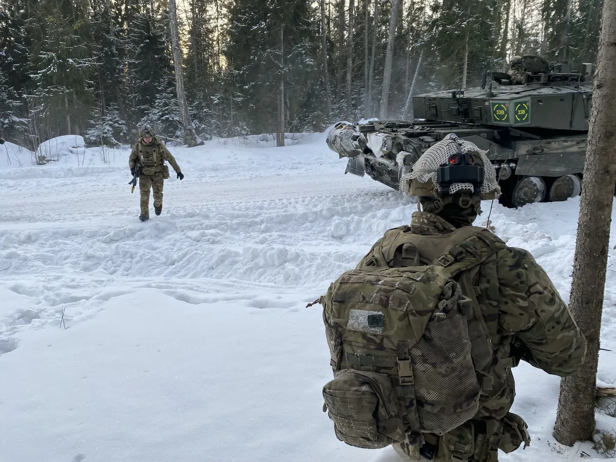 A soldier walks through the snow-covered military training area. During a winter exercise in Estonia, NATO troops are training to protect and defend NATO's eastern flank in cold winter conditions.