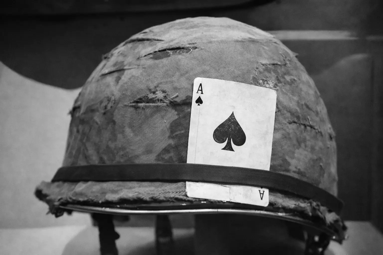 An Ace of Spades card attached to an M1 helmet.