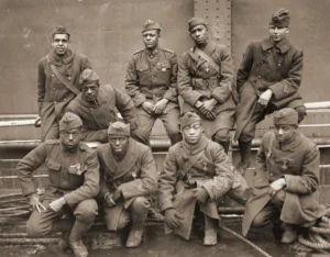 African-American soldiers of the 369th (15th NY) regiment, who won the Croix de Guerre for gallantry in action in WWI; they are (front row), left to right: Pvt Ed 'Eagle Eye' Williams, Pvt Herbert 'Lamp Light' Taylor, Pvt Leon E Fraiter, Pvt Ralph 'Kid Hawk' Hawkins; (back row), left to right: Sgt Henry Davis Primas Sr, Daniel W Storms Jr, Pvt Joe 'Kid Woney' Williams, Pvt Alfred 'Kid Buck' Manley, Corporal Tyler W Taylor