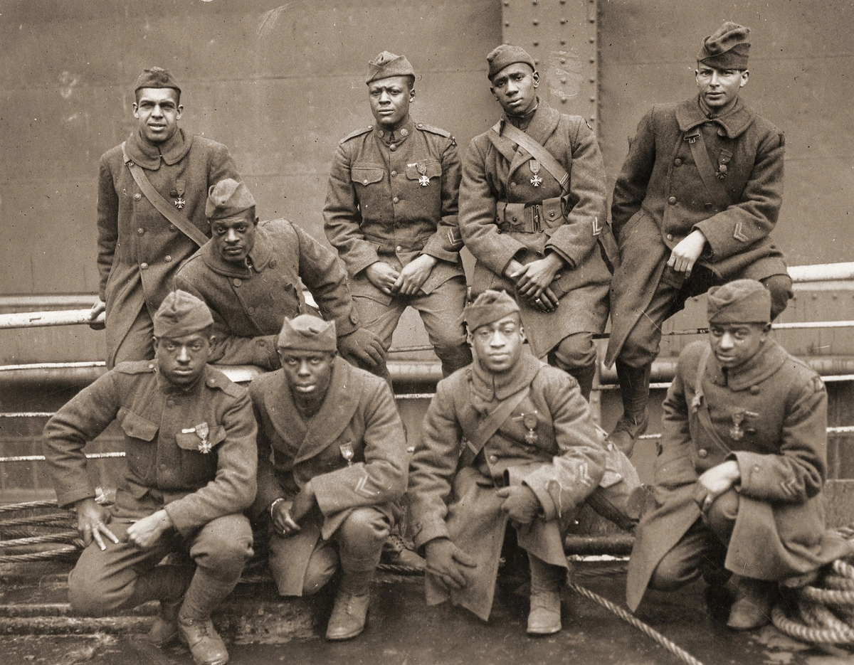 African-American soldiers of the 369th (15th NY) regiment, who won the Croix de Guerre for gallantry in action in WWI; they are (front row), left to right: Pvt Ed 'Eagle Eye' Williams, Pvt Herbert 'Lamp Light' Taylor, Pvt Leon E Fraiter, Pvt Ralph 'Kid Hawk' Hawkins; (back row), left to right: Sgt Henry Davis Primas Sr, Daniel W Storms Jr, Pvt Joe 'Kid Woney' Williams, Pvt Alfred 'Kid Buck' Manley, Corporal Tyler W Taylor