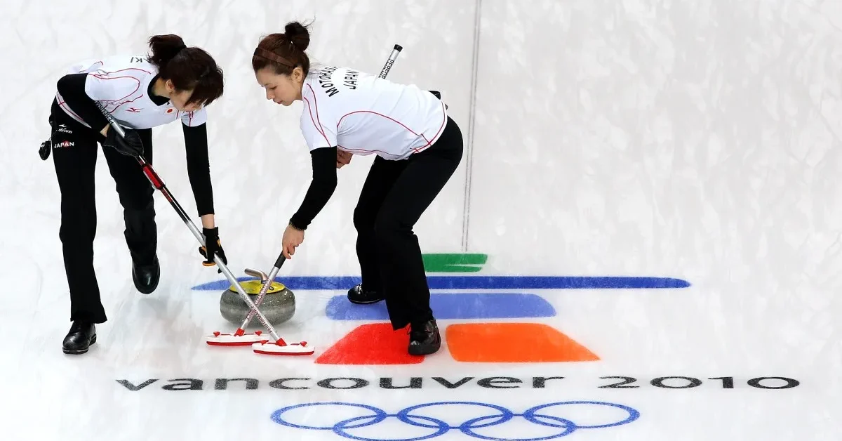VANCOUVER, BC - FEBRUARY 16: Skip Moe Meguro (R) and Kotomi Ishizaki of Japan sweep a path for the stone during the women's curling round robin game between Japan and the United States on day 5 of the Vancouver 2010 Winter Olympics at Vancouver Olympic Centre on February 16, 2010 in Vancouver, Canada.