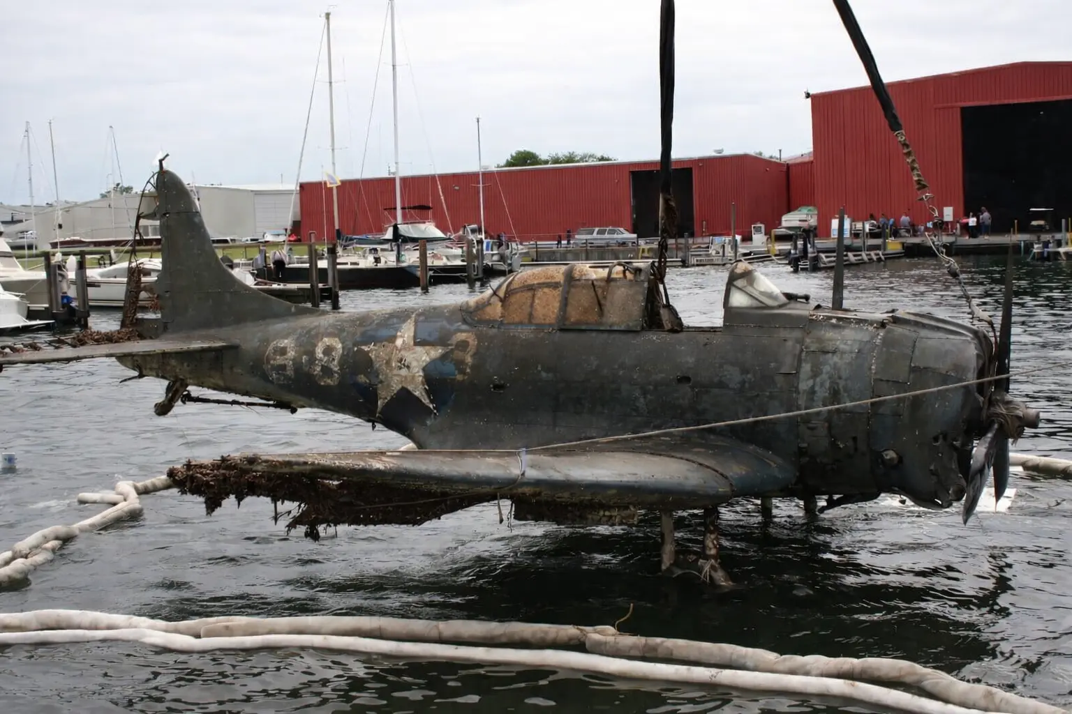 An image of the SBD Dauntless BuNo 2106 after being underwater for 50 years being taken out.
