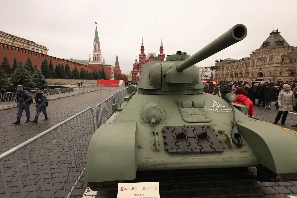 Officers or Russian National Guard Service walk past a Soviet T-34 tank during the festival, marking the 1941 Battle of Moscow, on November 7, 2025 in Moscow, Russia.