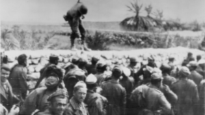 American soldiers hands out cigarettes to captured Italians of the Bersaglieri Division near El Guettar, Tunisia, March 1943