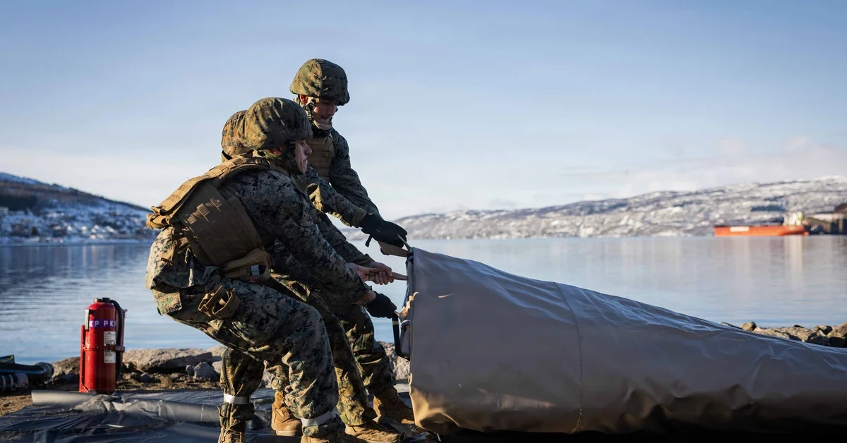 U.S. Marines with 6th Engineer Support Battalion, 4th Marine Logistics Group, Marine Forces Reserve, drag a fuel berm into place in Narvik, Norway, March 2, 2026. The Marines set up the bulk fuel equipment to establish a Joint Petroleum Off-the-Shore operation as part of exercise Cold Response 26.
