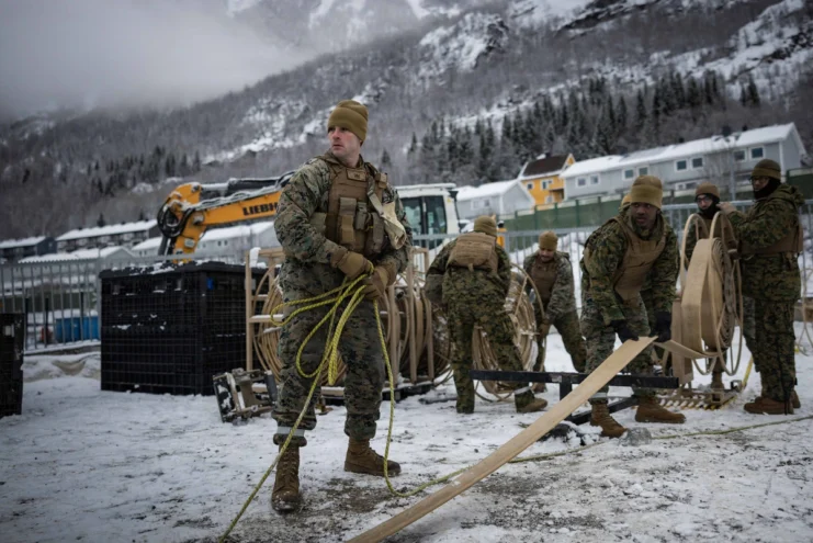 U.S. Marines with 6th Engineer Support Battalion, 4th Marine Logistics Group, Marine Forces Reserve, unroll a three-inch fuel hose in Narvik, Norway, March 4, 2026.