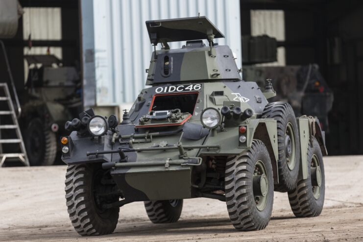Ferret Armoured Car driving past a workshop