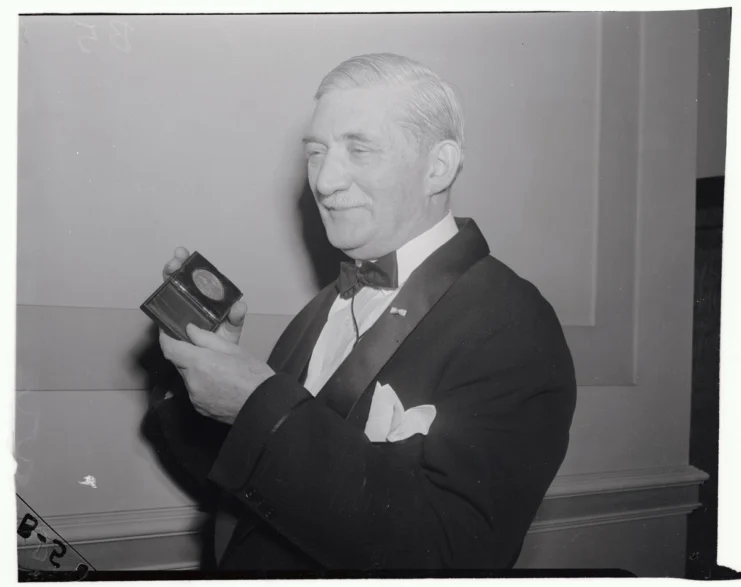 William Knudsen, co-director of the Office of Production Management, receives the Vermilye Medal for "outstanding contribution in the field of industrial management" from Philip Staples, President of the Franklin Institute, which made the award, Dec.1, 1941, at a dinner in Philadelphia's Franklin Hall.