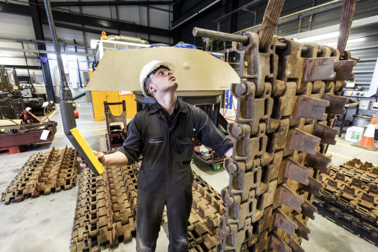 Worker standing next to the tracks from King Tiger V2
