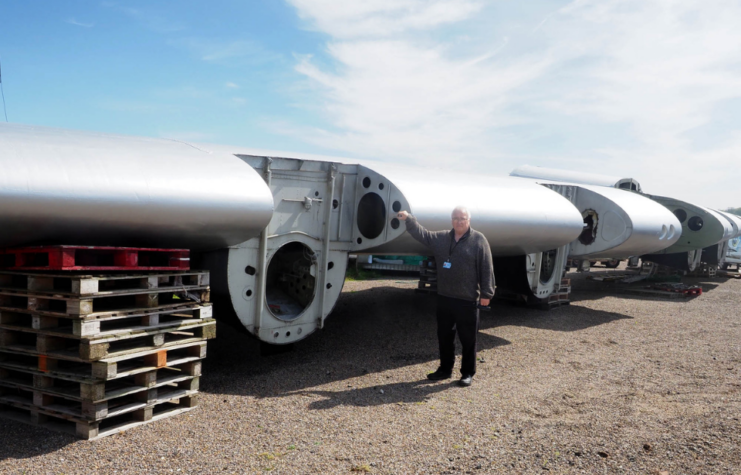 Man standing next to the wing of an aircraft