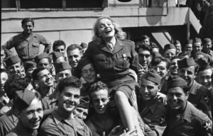 Marlene Dietrich held up by American GIs.