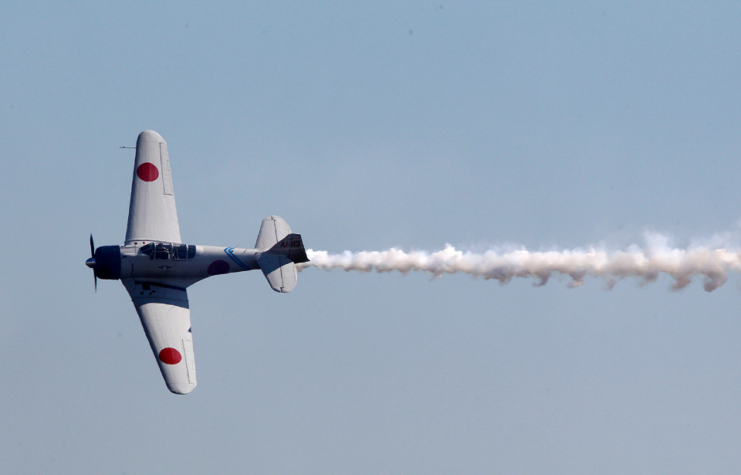 A Zero flying through a blue sky.