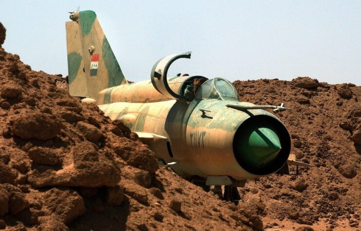 An Iraqi Air Force MiG fighter jet is partially buried in the sand near the Tamous air base August 2, 2003.