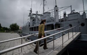 Korean People's Army (KPA) guide walks aboard the USS Pueblo at the Victorious Fatherland Liberation War Museum in Pyongyang.